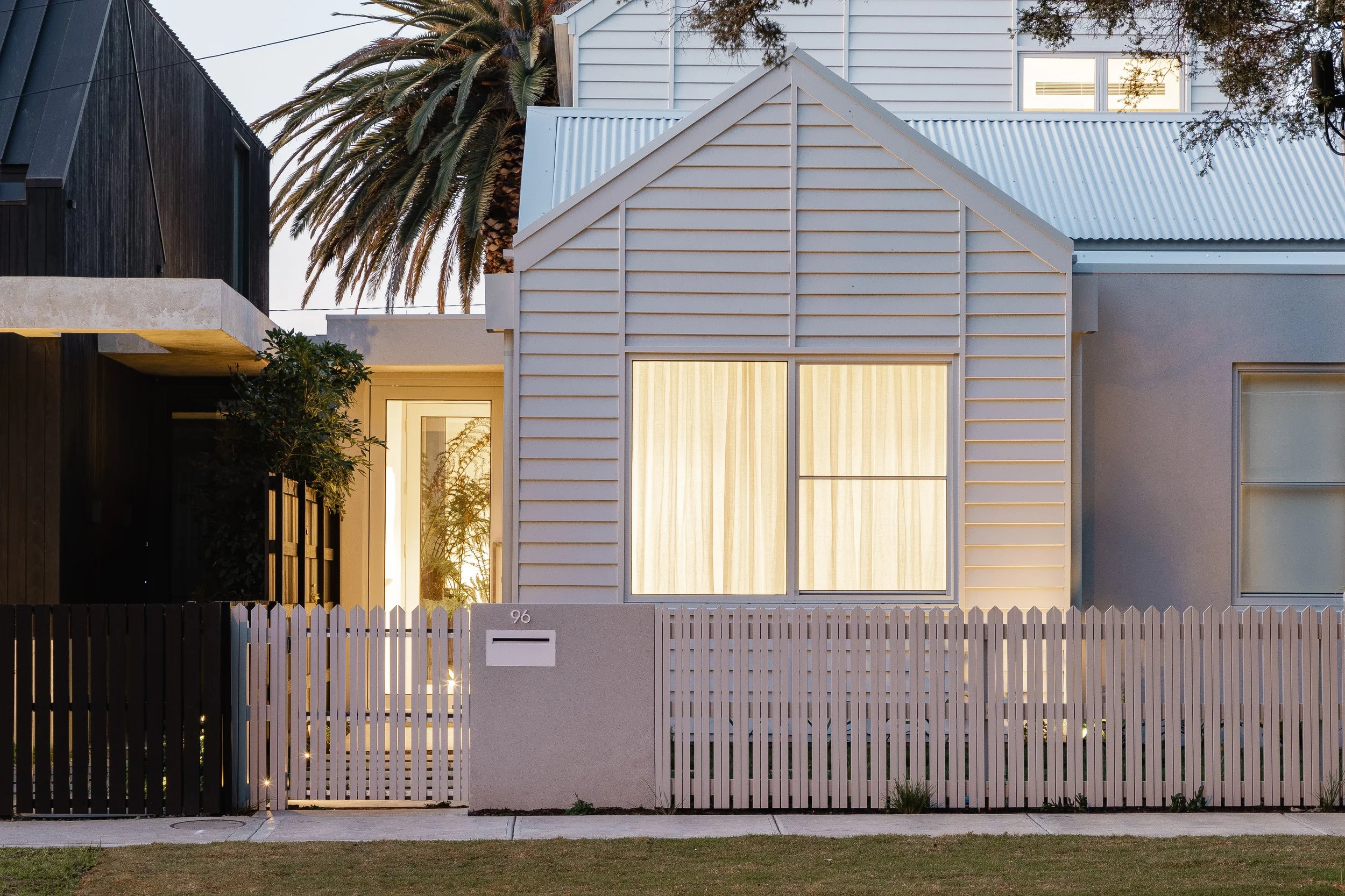Modern Melbourne home at dusk with warm architectural lighting installed by Priore Electrical